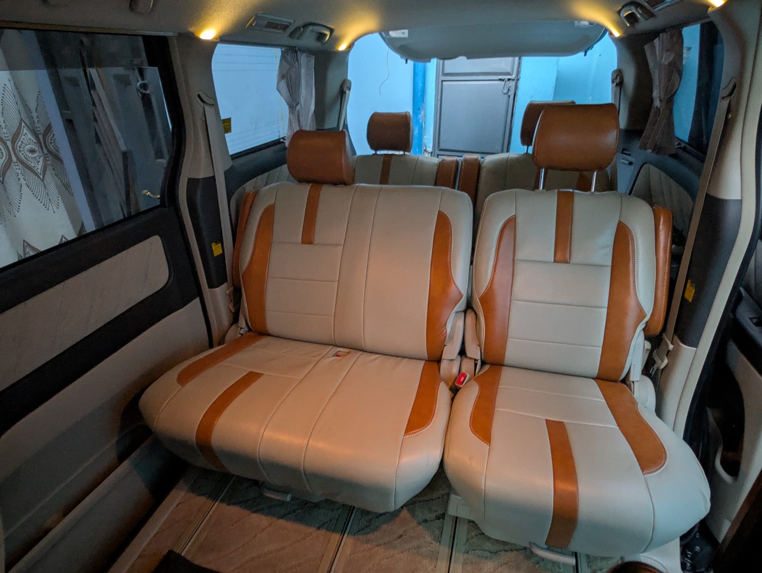 Comfortable cream and brown passenger seats inside the Toyota Alphard